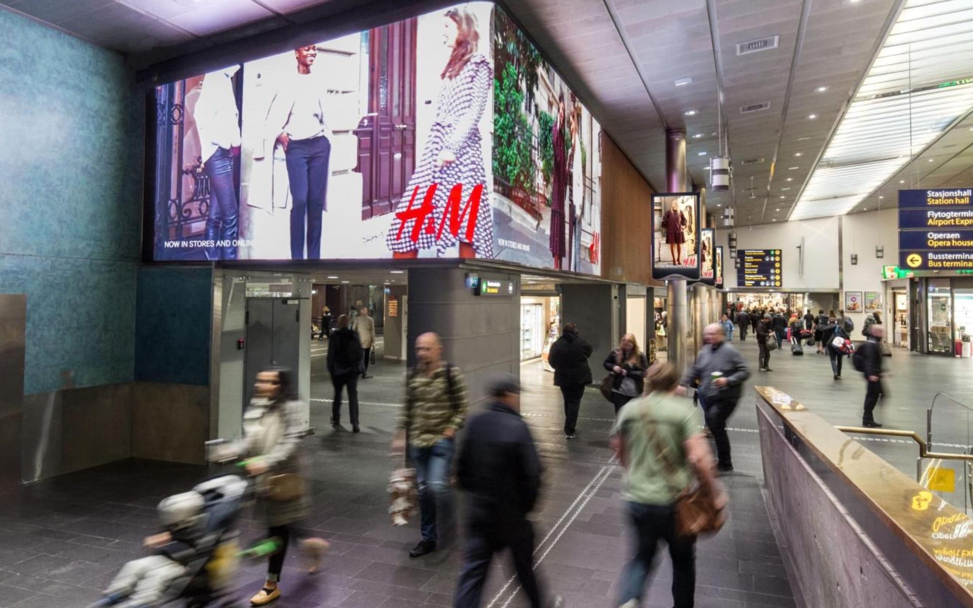 Large-format digital screens display H&M advertising at Oslo Central Station in Norway