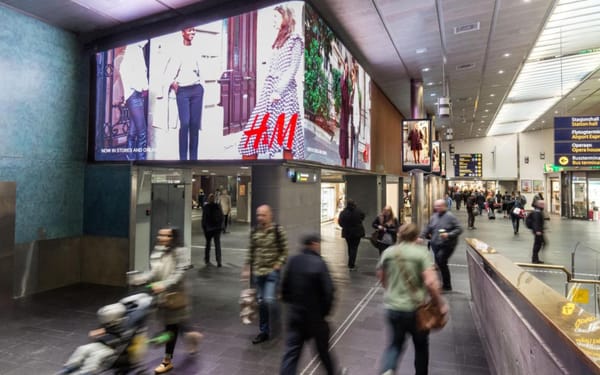 Large-format digital screens display H&M advertising at Oslo Central Station in Norway