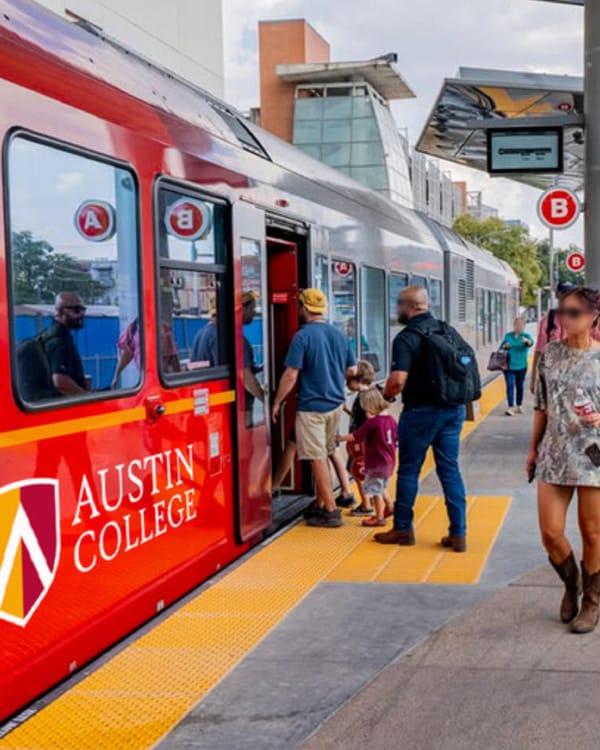 CapMetro rail transit platform in Austin with commuters boarding red train at modern station